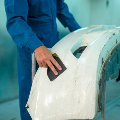 worker-sands-car-bumper-in-repair-shop-2026-03-17-04-24-41-utc.jpg